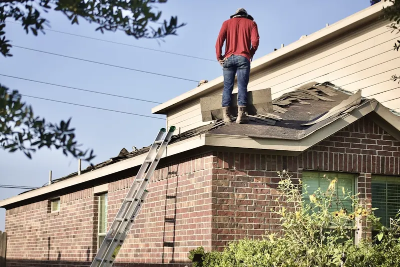 Professional roofer working on a residential roof in Kings Park